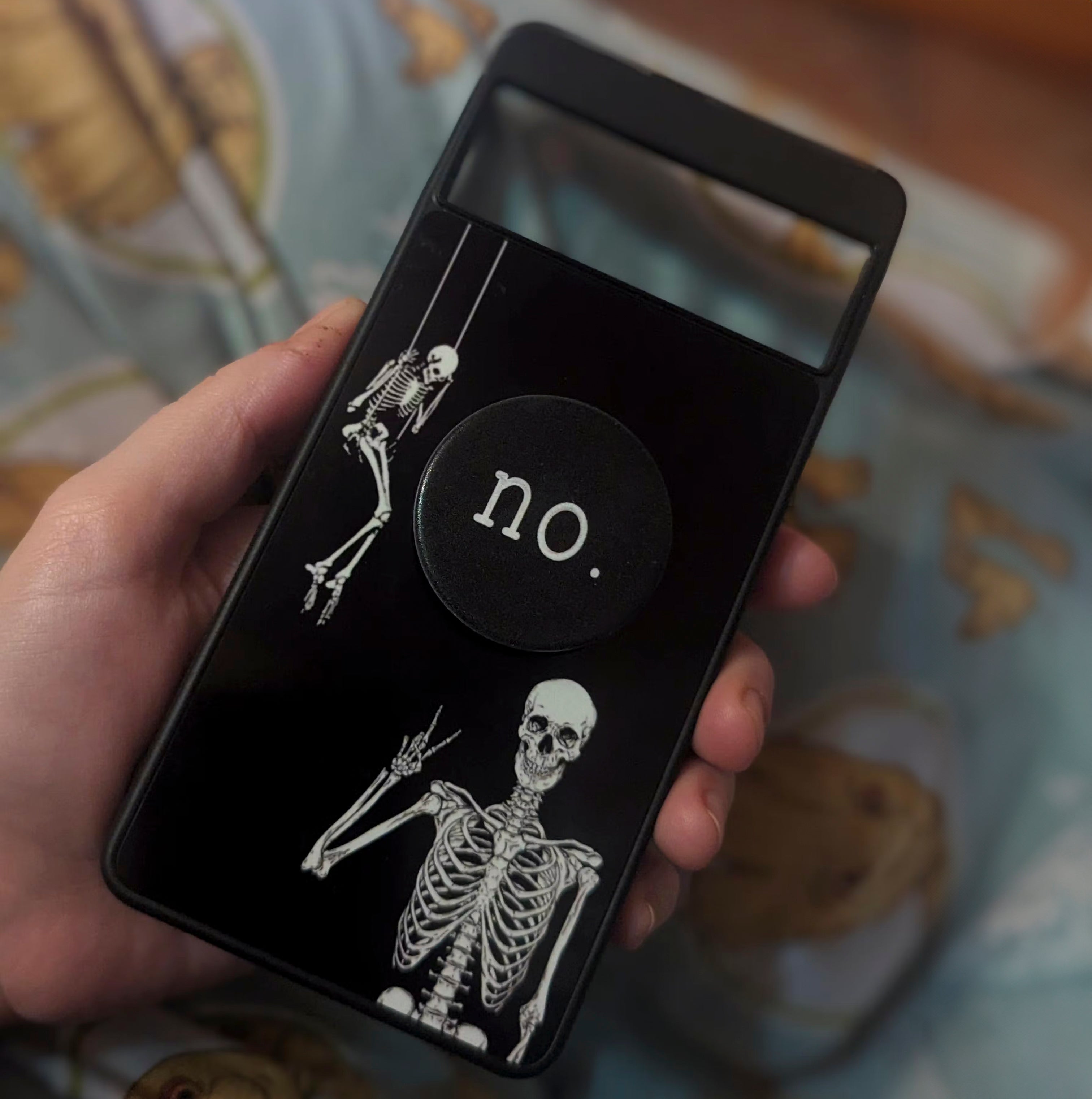 A custom google pixel phone case with skeletons on it.