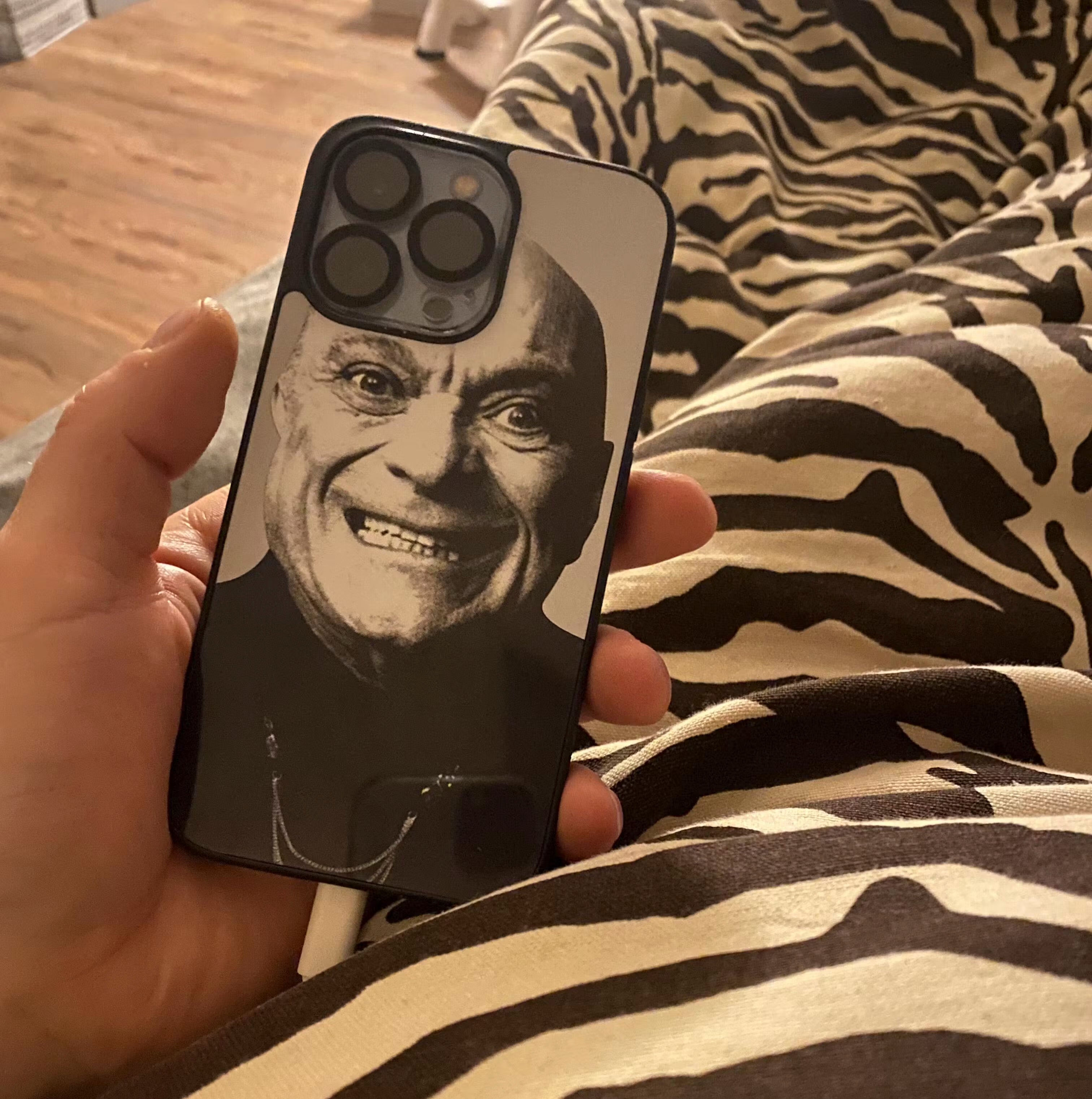 A custom apple iphone case with a man smiling on it.