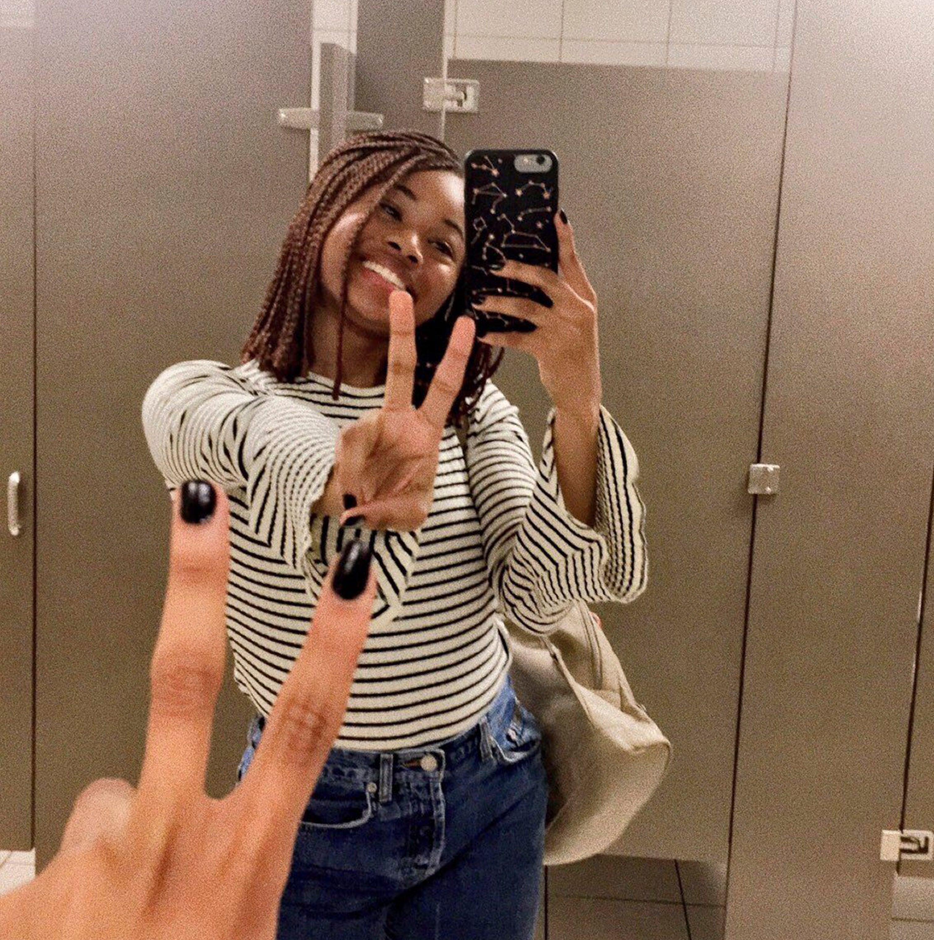 a girl holding a custom iphone 7 plus phone case taking a selfie and giving a peace sign.
